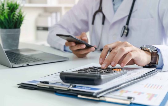 doctor calculating cataract surgery costs