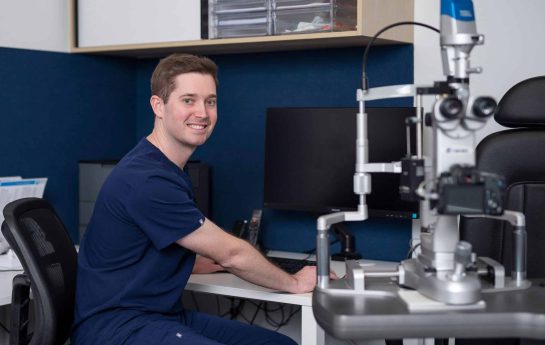 Dr Geoffrey Ryan smiling in his office