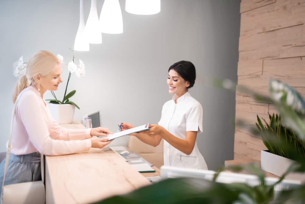 Patient signing papers in a medical office