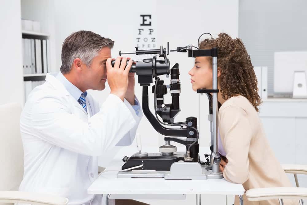 Doctor performing an eye exam on a patient